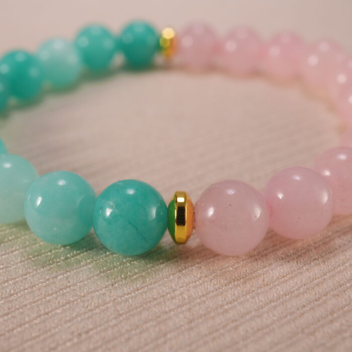 Close-up of rose quartz and amazonite bracelet in soft pastel colors.