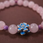 Close-up of rose quartz bracelet with soft pink translucent beads.