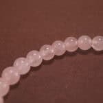 Close-up of rose quartz bracelet.