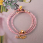 Full view of the necklace laid flat, highlighting the gentle color transition between the two pink stones.