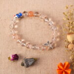 Rutilated quartz bracelet under daylight, highlighting internal golden threads.