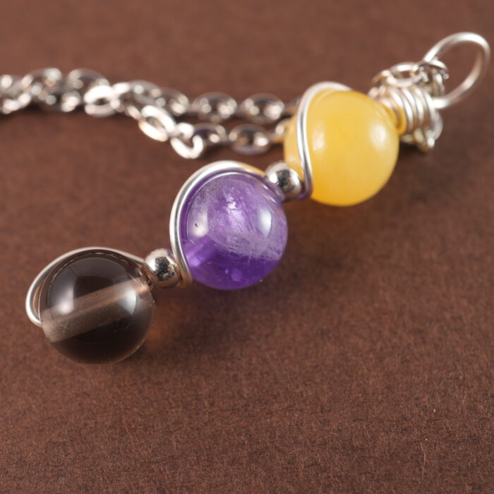 Close-up of Sagittarius necklace showing yellow chalcedony, amethyst, and smoky quartz beads.