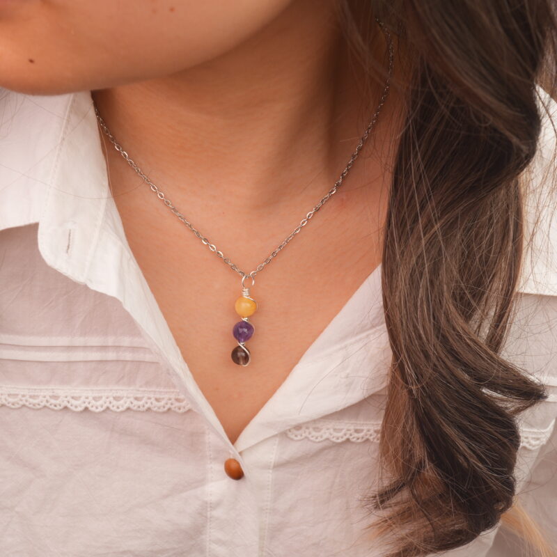 Model wearing Sagittarius zodiac necklace with yellow chalcedony, amethyst, and smoky quartz.