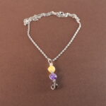 Sagittarius zodiac necklace with yellow chalcedony, amethyst, and smoky quartz gemstones.