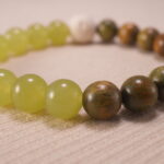 Close-up of sandalwood and lava stone bracelet.