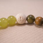 Close-up of sandalwood and lava stone bracelet.