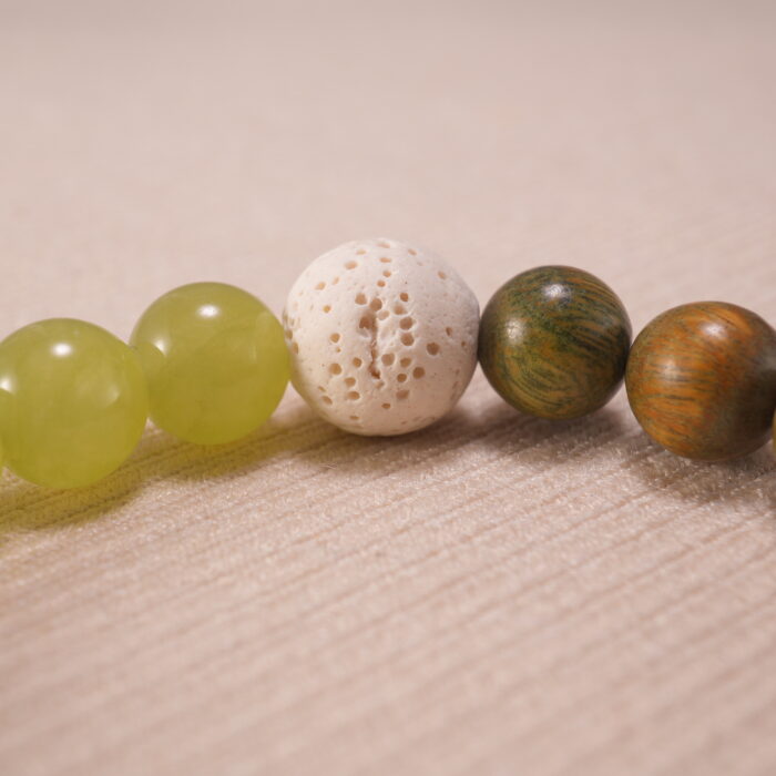 Close-up of sandalwood and lava stone bracelet.