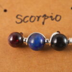 Close-up of Scorpio necklace showing obsidian, lapis lazuli, and garnet beads.