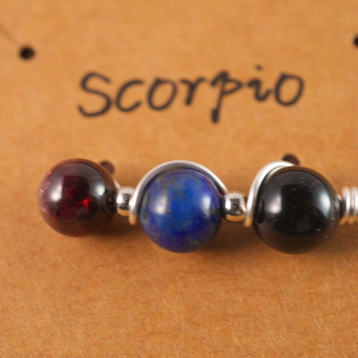 Close-up of Scorpio necklace showing obsidian, lapis lazuli, and garnet beads.