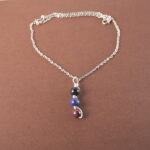 Scorpio zodiac necklace with obsidian, lapis lazuli, and garnet gemstones.