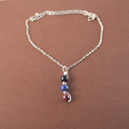 Scorpio zodiac necklace with obsidian, lapis lazuli, and garnet gemstones.