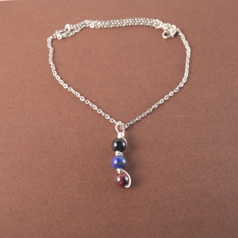 Scorpio zodiac necklace with obsidian, lapis lazuli, and garnet gemstones.