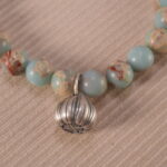 Close-up of Shoushan stone bracelet with S925 silver details.