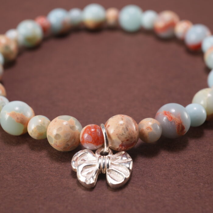 Close-up of shoushan stone bracelet with S925 silver accents.