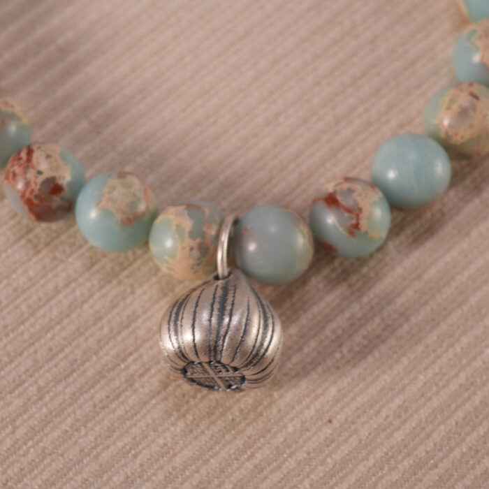 Close-up of Shoushan stone bracelet with S925 silver details.