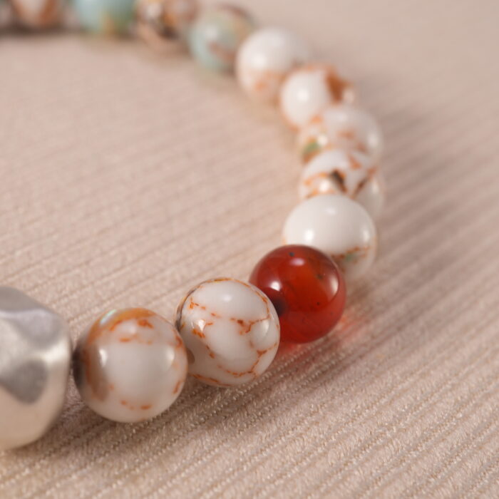 Close-up of Shoushan stone bracelet with sterling silver accents.