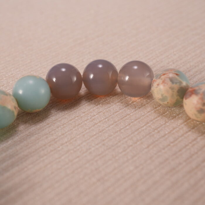 Close-up of Shoushan stone bracelet with S925 silver details.