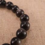 Close-up of silver obsidian bracelet with S925 silver details.