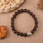 Smoky quartz bracelet in warm natural light with smoky transparency.
