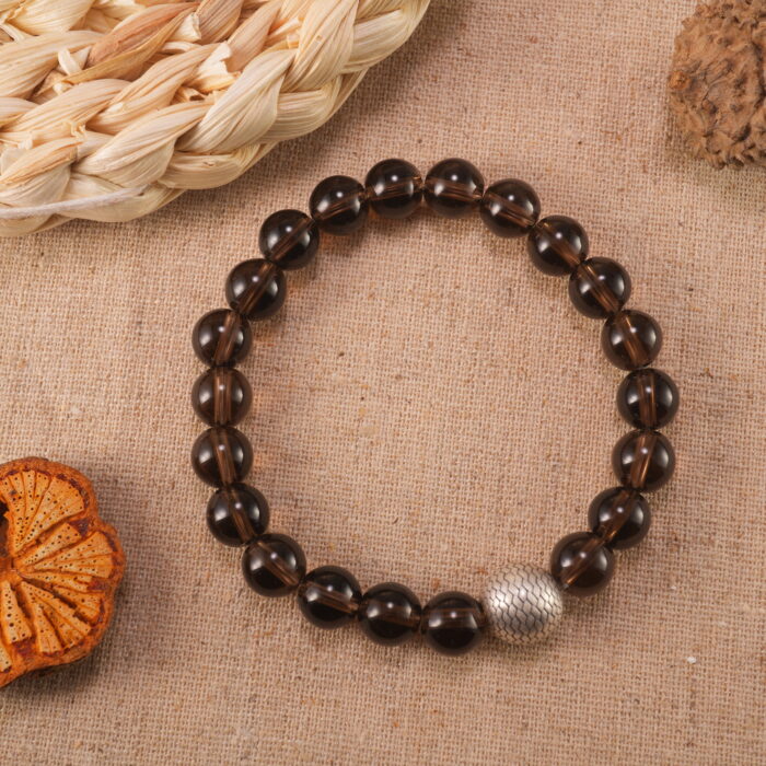 Smoky quartz bracelet in warm natural light with smoky transparency.