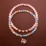 Main image of stacked bracelets with natural and pink stones.