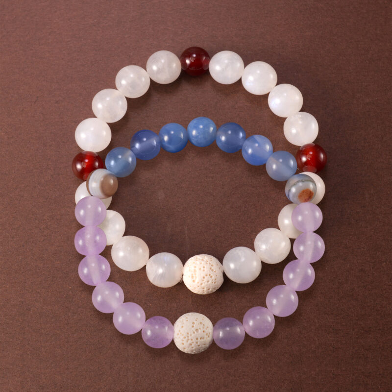 Main image of stacked bracelets in purple, white, and red tones.