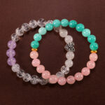 Main image of stacked gemstone bracelets in purple, pink, and aqua tones.