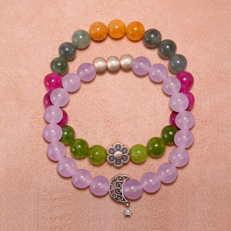 Main product image showing stacked amethyst and tourmaline crystal bracelets.