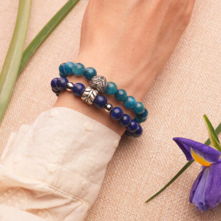 Model wearing blue apatite and lapis lazuli stacked bracelets.