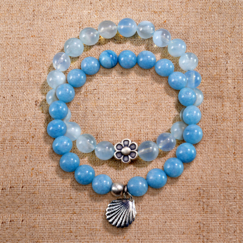Main image showing stacked bracelets of blue chalcedony and aquamarine.