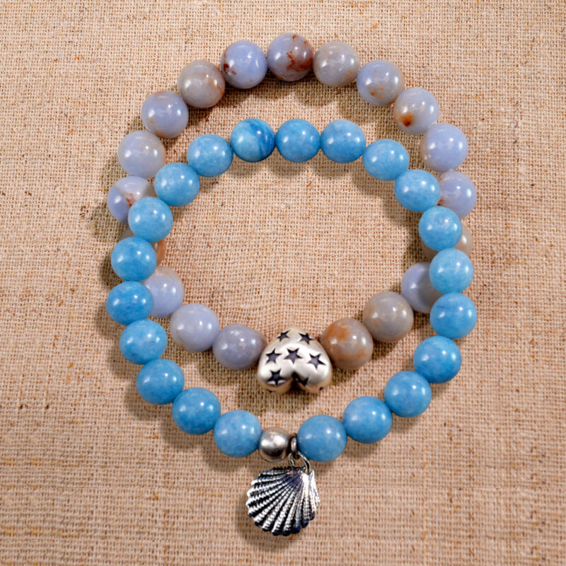 Main product image showing stacked blue and cream chalcedony bracelets.