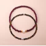 Main image of stacked garnet, pearl and tourmaline bracelets.
