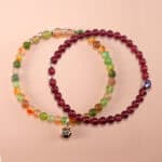 Main image of stacked garnet and yellow-green chalcedony bracelets.