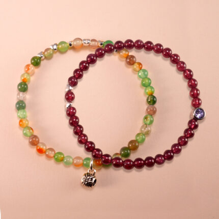 Main image of stacked garnet and yellow-green chalcedony bracelets.