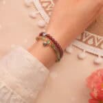 Model wearing gemstone stack in vibrant contrast.