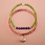 Main image of stacked green chalcedony, amethyst and strawberry quartz bracelets.
