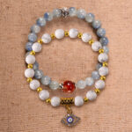 Main image of stacked bracelets in kyanite, red agate, and howlite.
