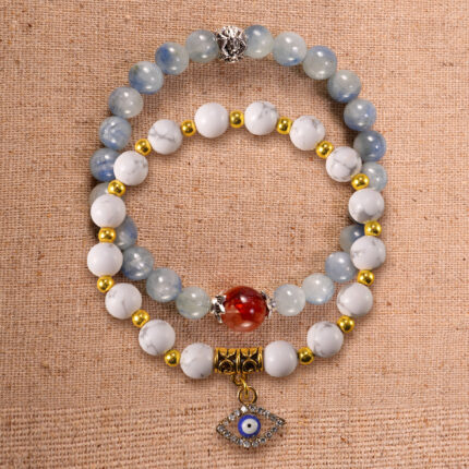 Main image of stacked bracelets in kyanite, red agate, and howlite.