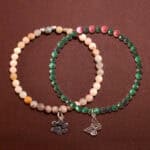 Main image of stacked bracelets in malachite green and pastel tones.