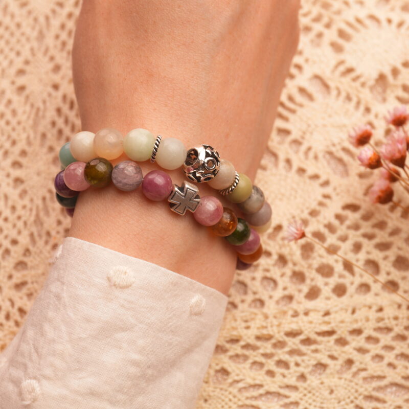Model wearing stacked multicolor amazonite and tourmaline bracelets.