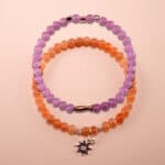 Main image of stacked peach moonstone and amethyst bracelets.