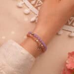 Model wearing soft warm and cool toned gemstone stack.