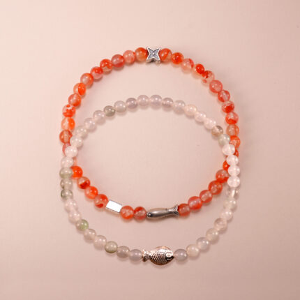 Main image of red carnelian and white chalcedony stacked bracelets.