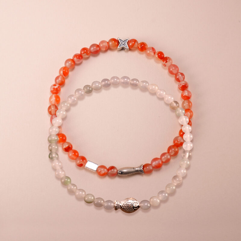 Main image of red carnelian and white chalcedony stacked bracelets.