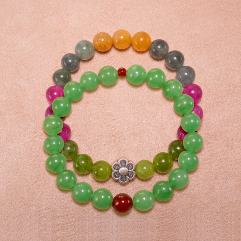 Main image showing stacked bracelets of tourmaline and aventurine-red agate mix.