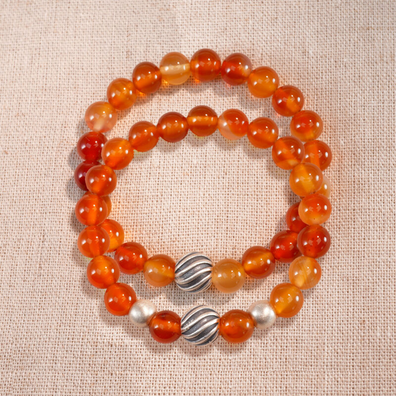 Main image featuring two stacked flower red agate bracelets.