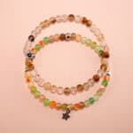 Main image of stacked yellow, white, and green chalcedony bracelets.