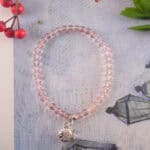Strawberry quartz bracelet in daylight with rosy sparkle.
