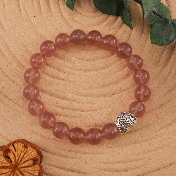 Strawberry quartz bracelet in soft natural light with pink sparkles.
