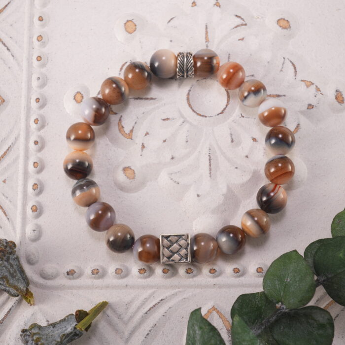 Striped agate bracelet in natural light showing soft bands and earthy tones.
